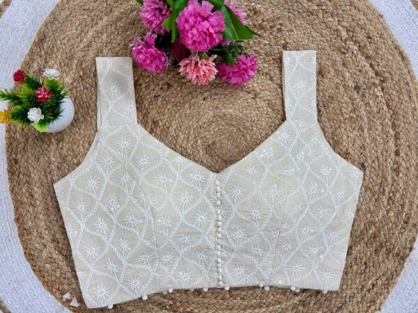 Beige khadi cotton sleeveless V-neck embroidered readymade blouse for festive and party wear.